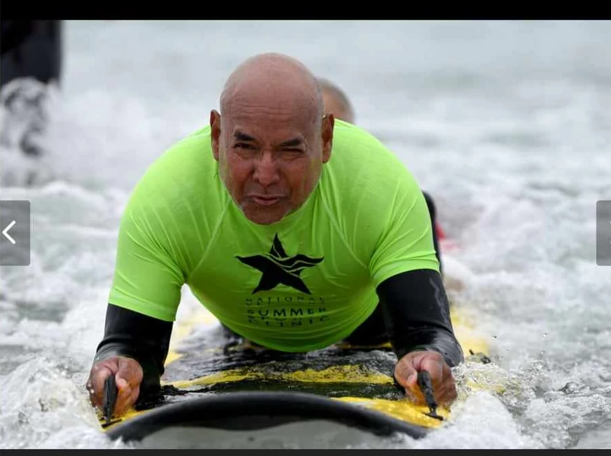 Richard Cooks participating in adaptive surfing